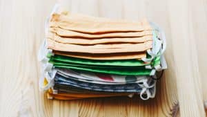 stack of white yellow green and blue textiles