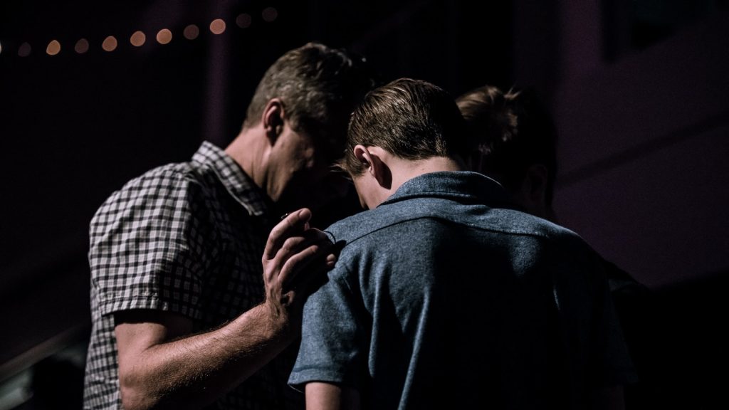 men touching each other's foreheads