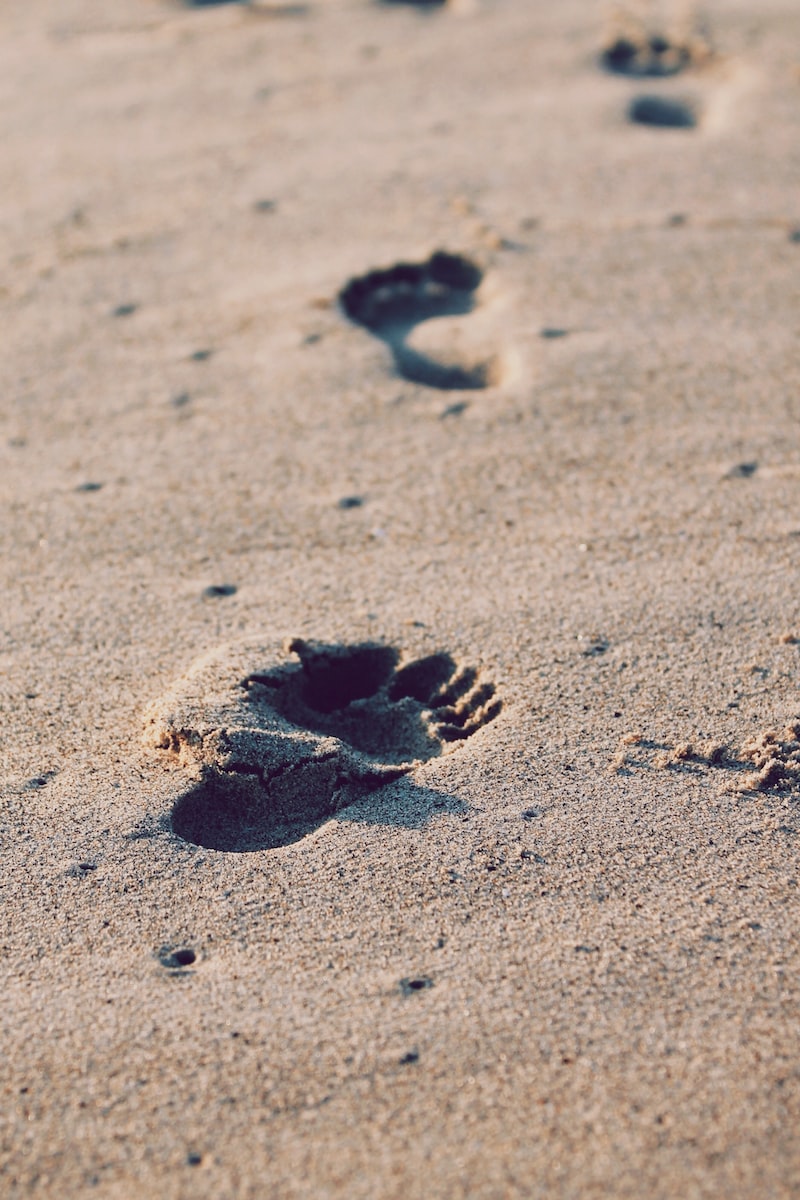 foot prints on beach sand