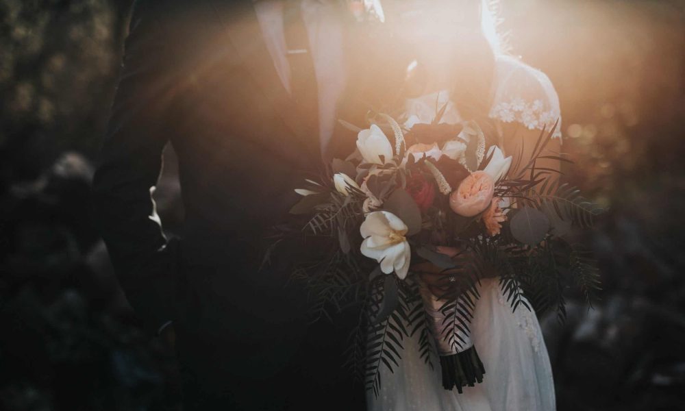 Photo by Nathan Dumlao groom beside bride holding bouquet flowers